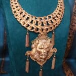 A necklace with chains and tassels hanging from it.