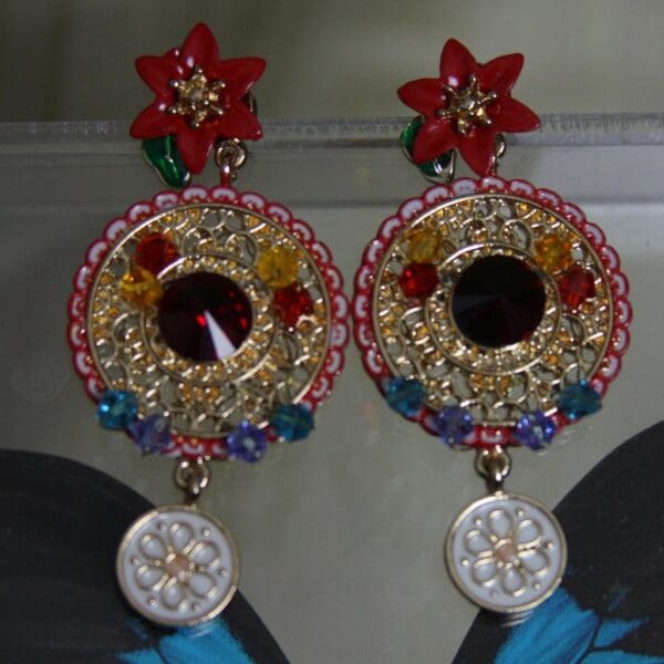 A pair of earrings with flowers and mirrors.