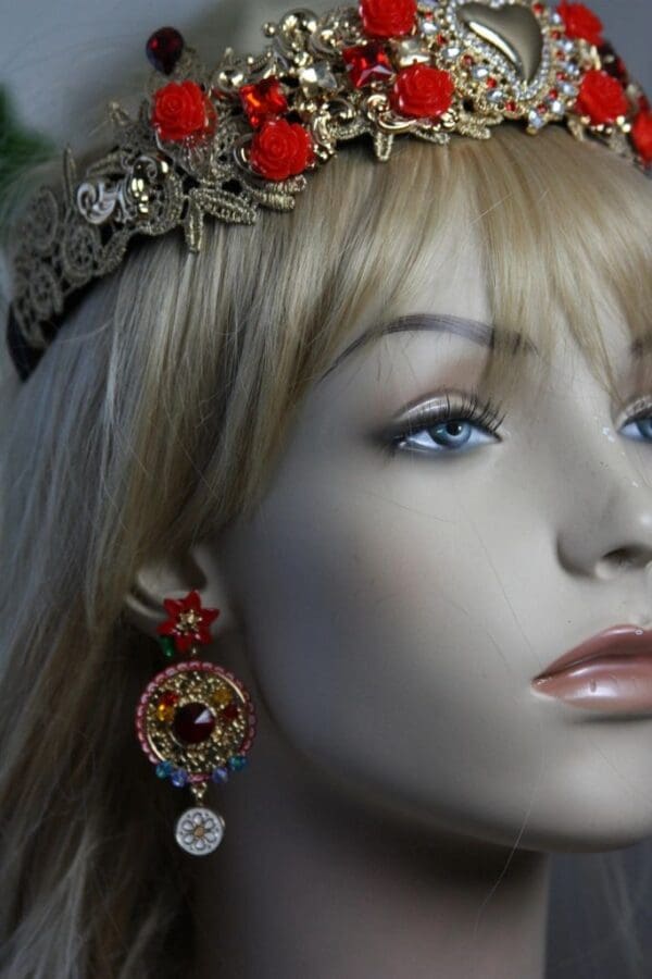 A mannequin wearing earrings and a headband.