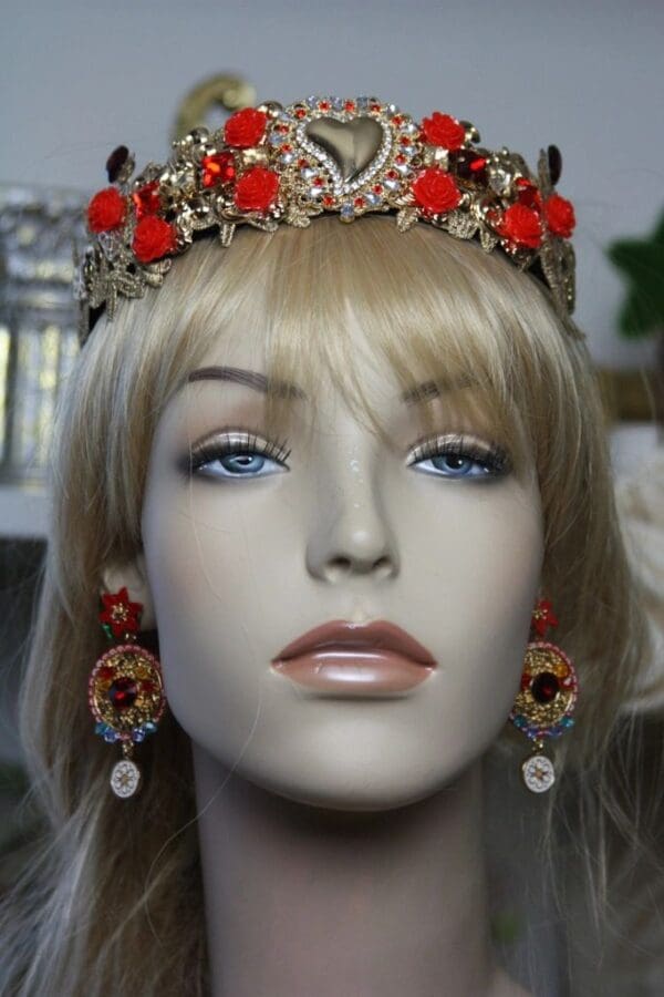 A mannequin wearing a crown and earrings.