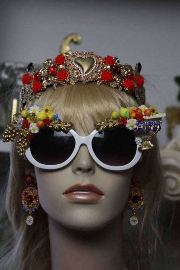 A mannequin wearing sunglasses and a crown.