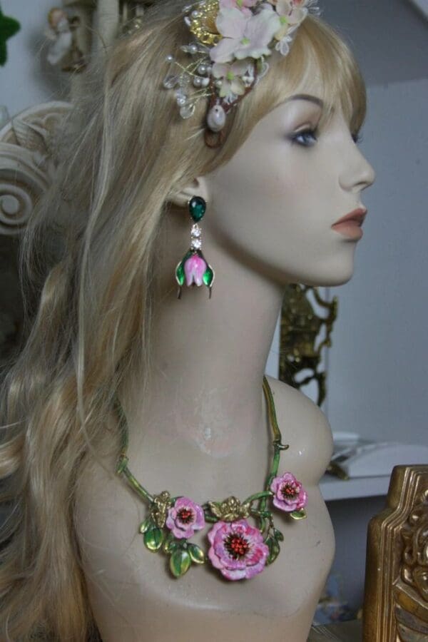 A mannequin wearing a necklace and earrings.