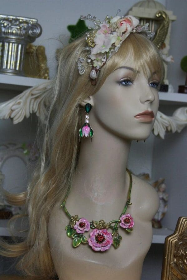 A mannequin wearing jewelry and a necklace.