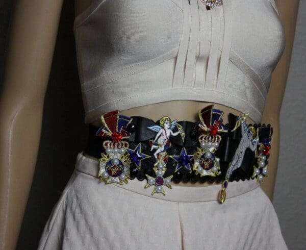 A close up of the waist of a woman wearing a white dress
