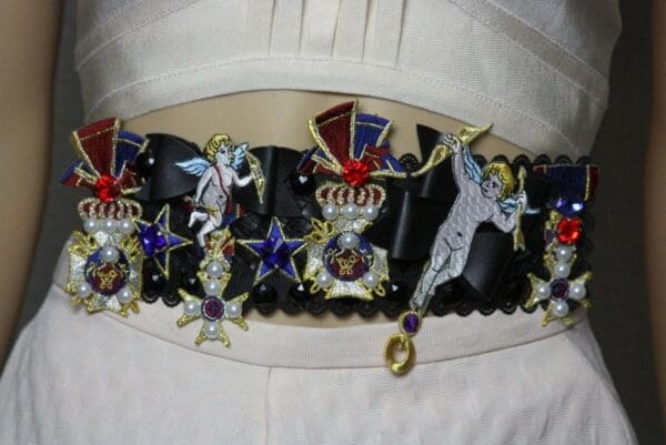 A close up of the belt with various decorations on it