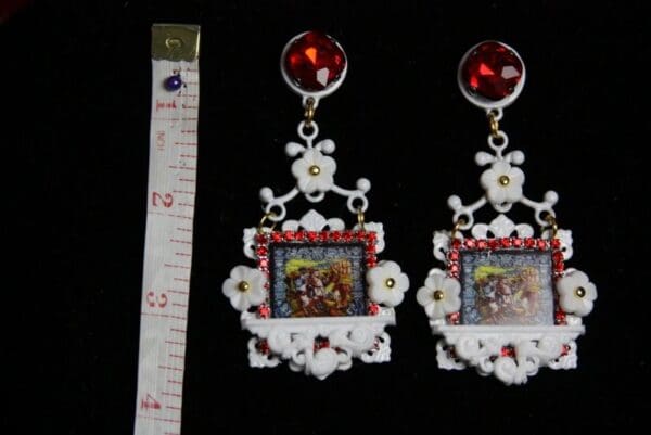 A pair of earrings with a picture on them