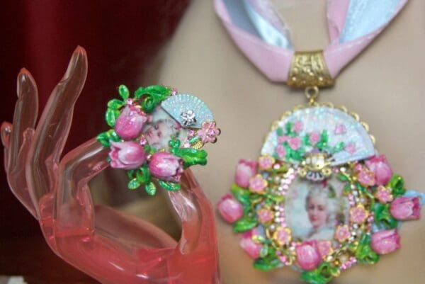 A pink shoe and a necklace with flowers on it