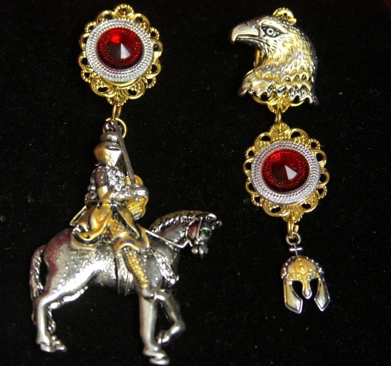A pair of earrings with a horse and rider.