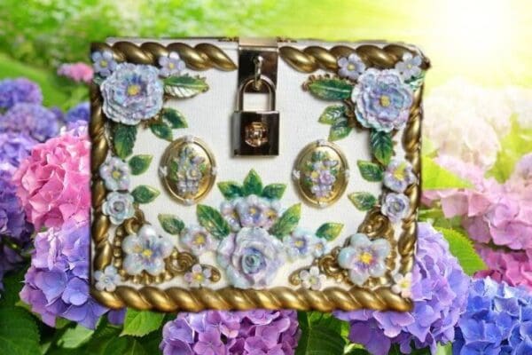 A white box with flowers and gold trim