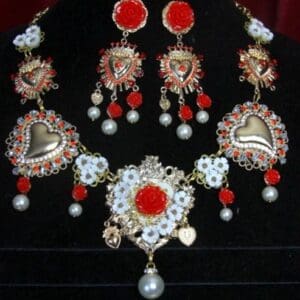 A necklace and earrings set with red stones.