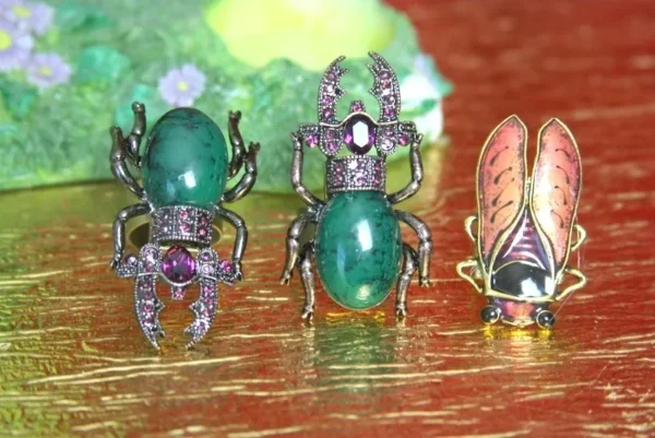 A close up of three different bugs on a table