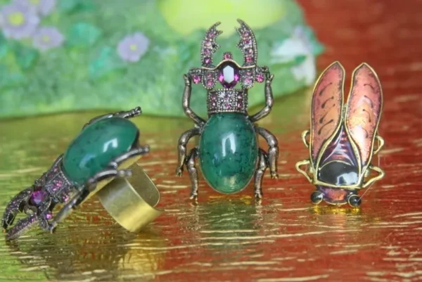 A close up of three rings with bugs on them