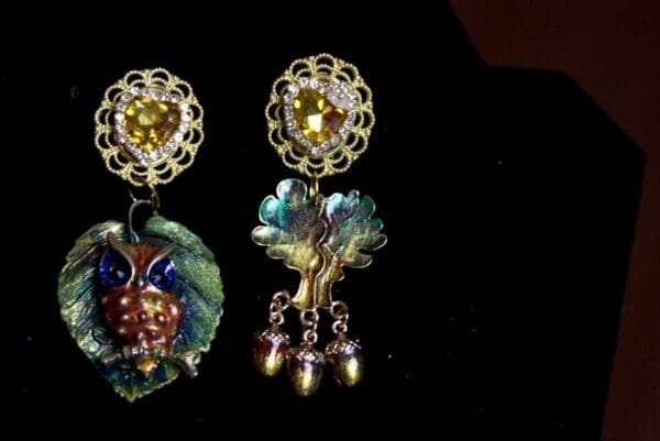 A close up of two earrings on display