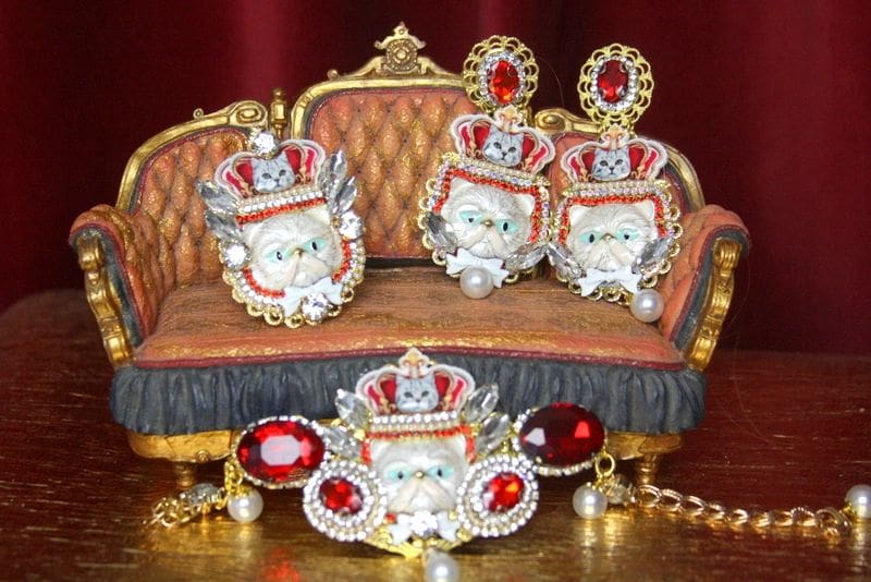 A couch with red pillows and a crown on it