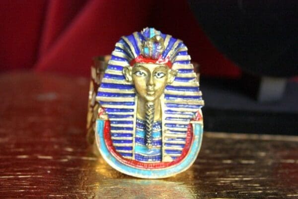 A close up of an egyptian ring on a table