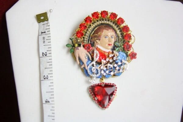 A small painting of a woman with roses and a heart.