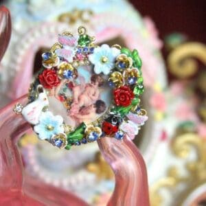 A close up of a person holding a wreath