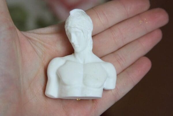 A person holding a white object in their hand.