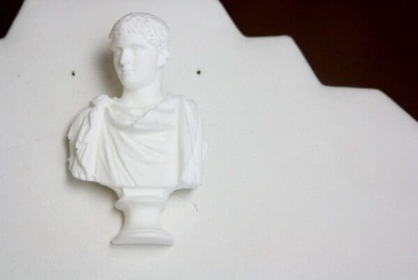 A white bust of a man on the wall.
