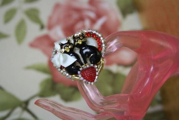 A heart shaped ring with red and black stones.