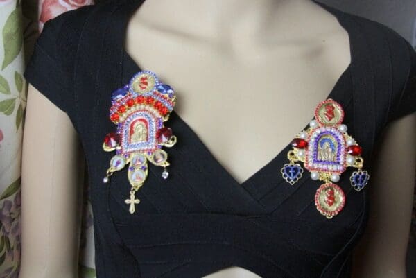 A close up of the collar of a woman wearing a black dress