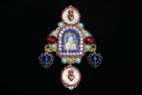 A close up of a brooch with the image of jesus