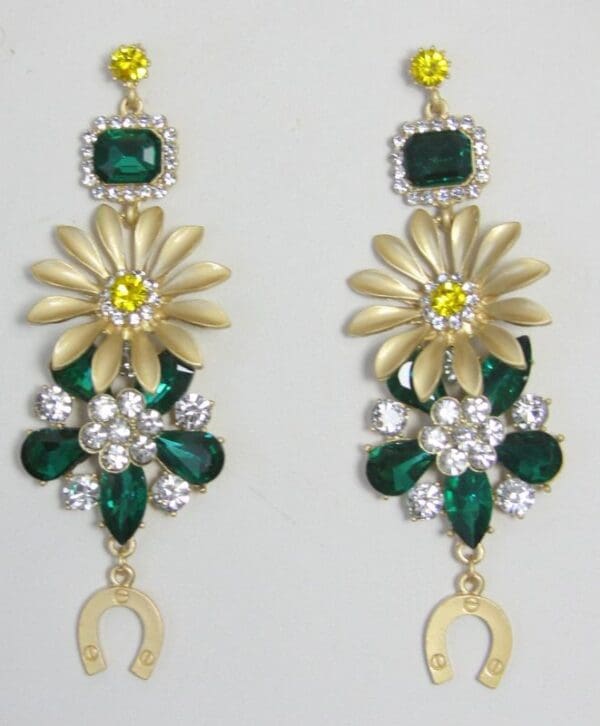 A pair of earrings with green and yellow flowers.