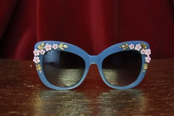 A pair of blue sunglasses with flowers on them.