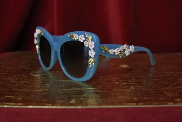 A pair of blue sunglasses with flowers on them.