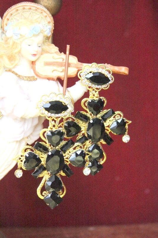 A pair of black and gold earrings hanging from the side.
