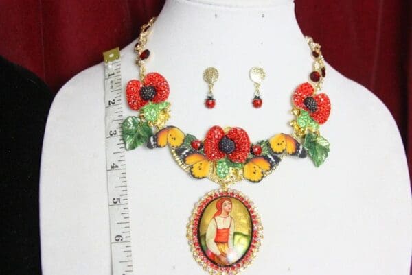 A necklace and earrings set with flowers on it.
