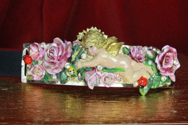 A decorative object with flowers and a little angel.