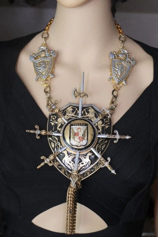 A woman wearing a necklace with various metal pieces.