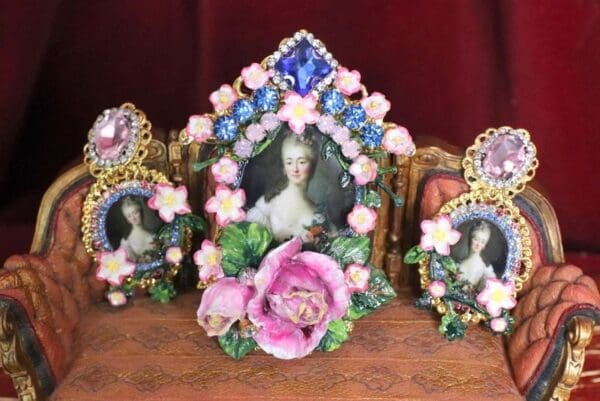 A set of three frames with flowers and pearls.