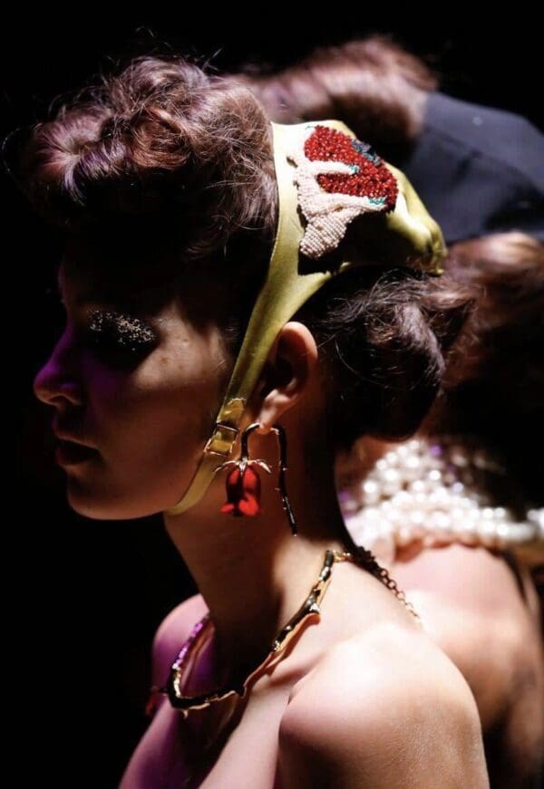 A woman with long hair and jewelry on her head.