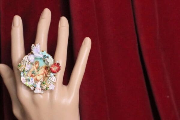 A hand with many different jewelry on it