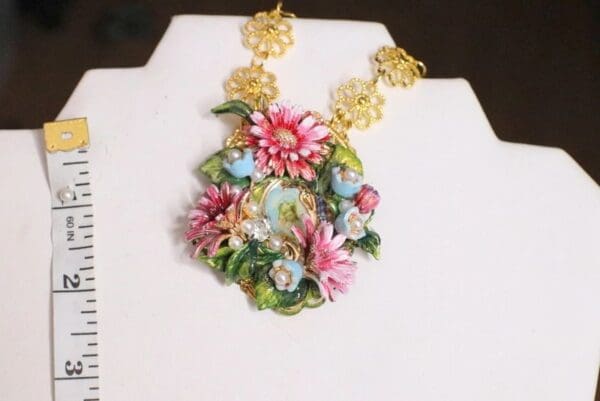 A necklace with flowers and leaves on it