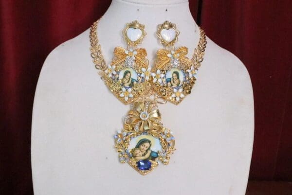 A necklace and earrings set with gold chains.