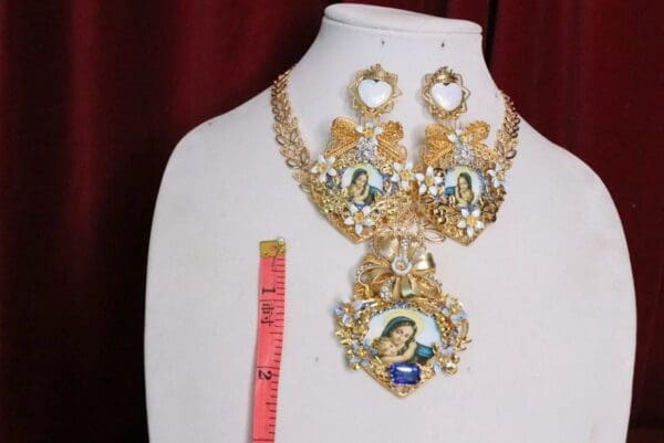 A necklace and earrings set with a picture of jesus.