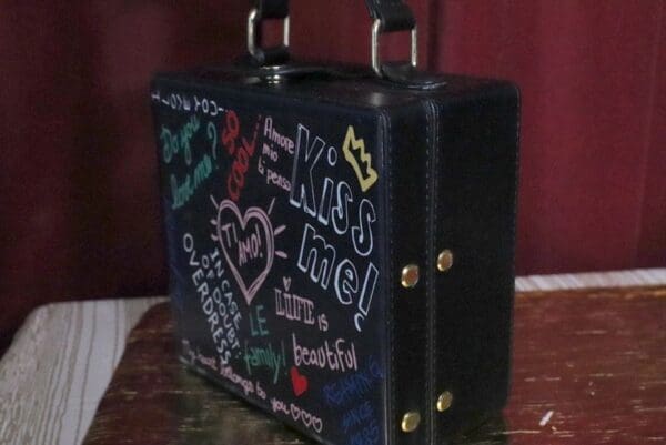 A black suitcase with writing on it