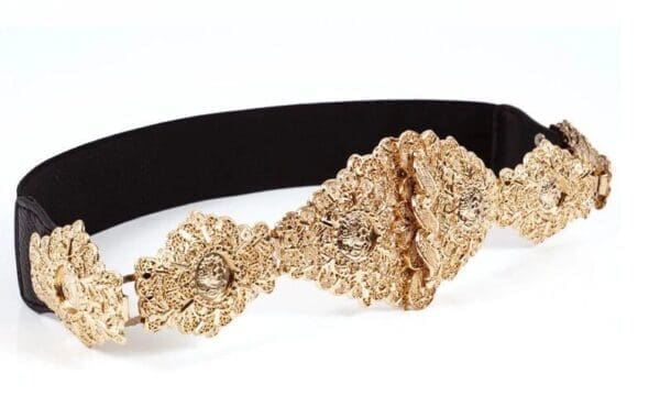 A close up of the side of a gold flower headband