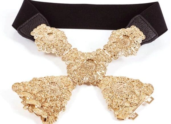 A close up of the gold cross on a black belt
