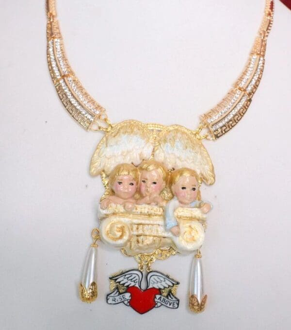 A necklace with three angels on it