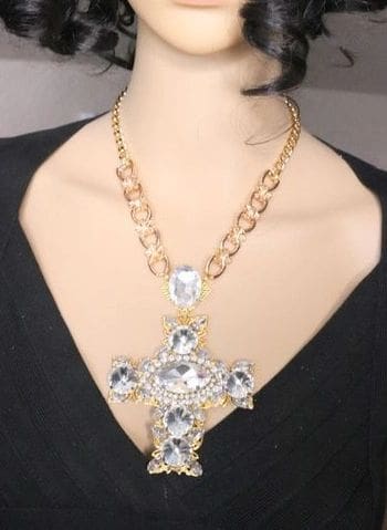 A woman wearing a necklace with a large cross.