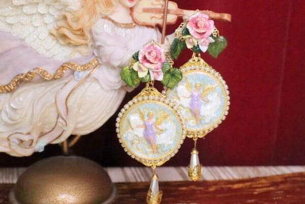 A close up of two angel ornaments on display.