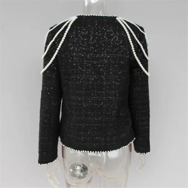 A black jacket with white trim on the shoulders.