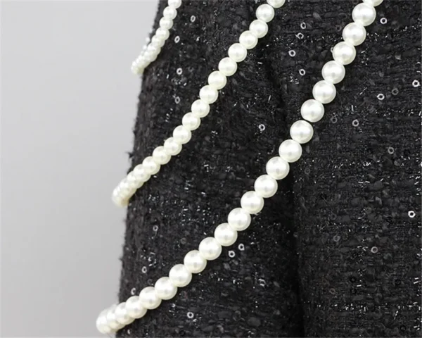 A close up of the pearls on a dress