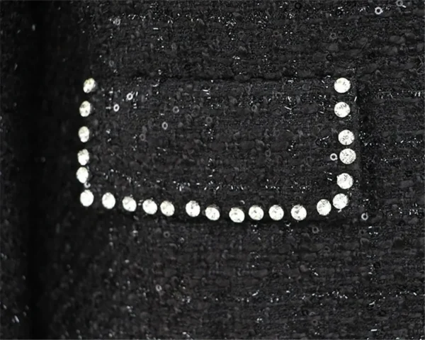 A black bag with white sequins on it.