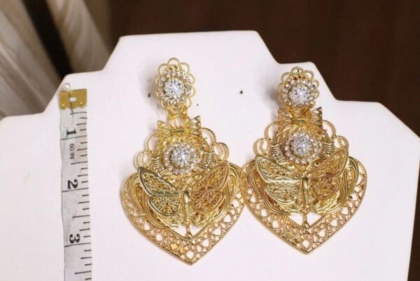 A pair of gold earrings with diamond accents.