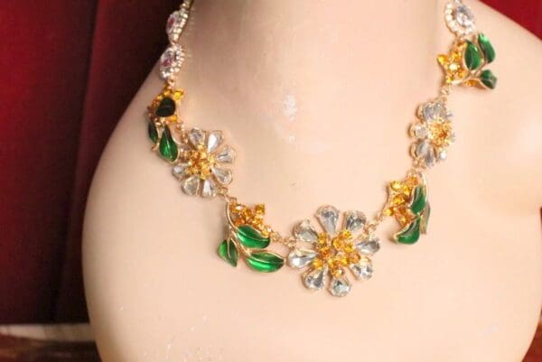 A close up of the necklace on a woman 's neck